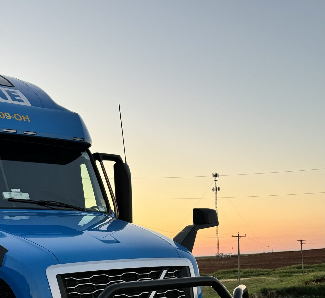Blue Caravan cab parked at twilight under deep blue evening sky